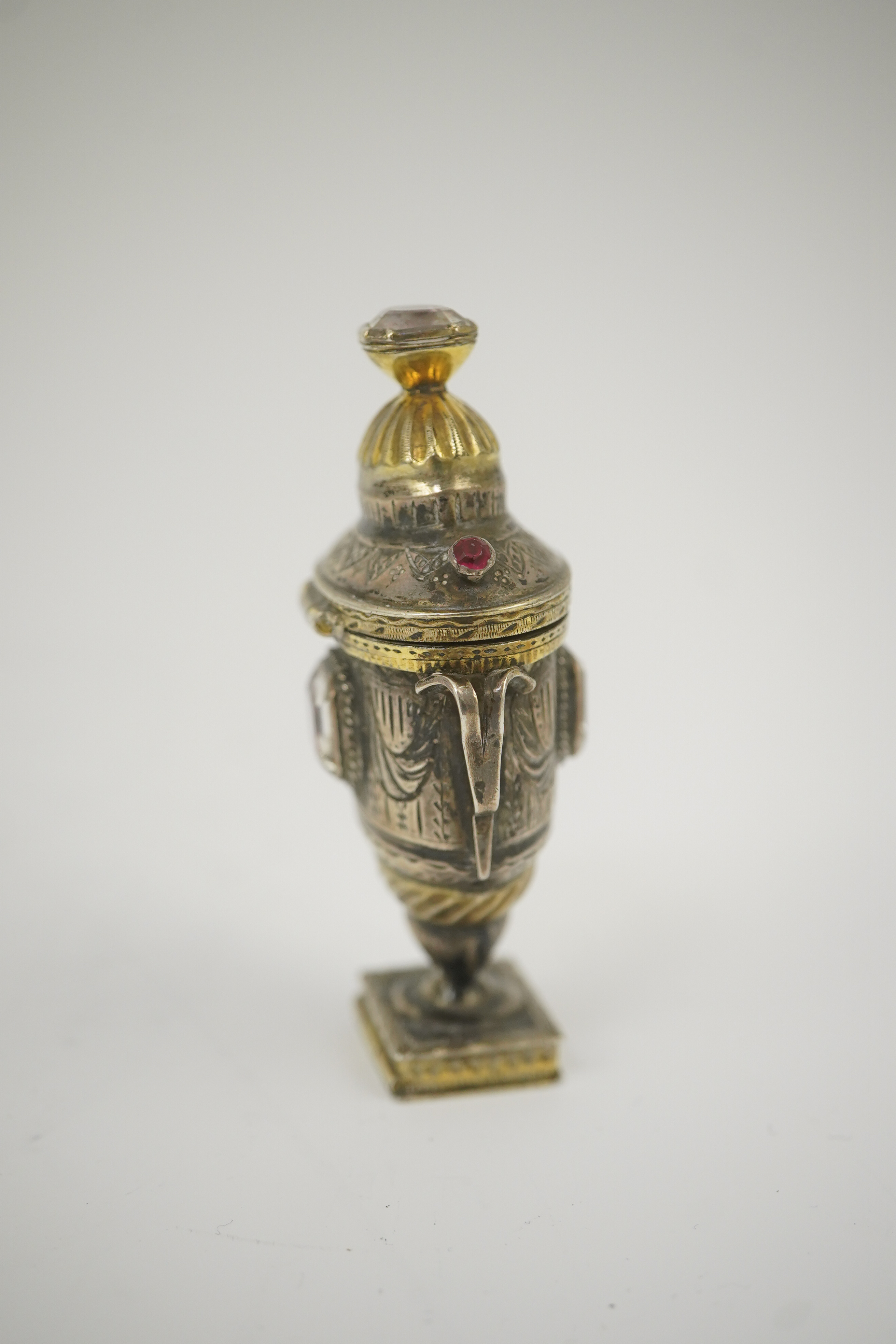 A 19th century continental parcel gilt silver and gem set double ended pill box, modelled as a two handle vase